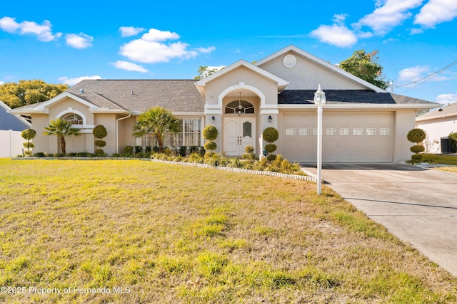 ranch-style home featuring a garage and a front yard