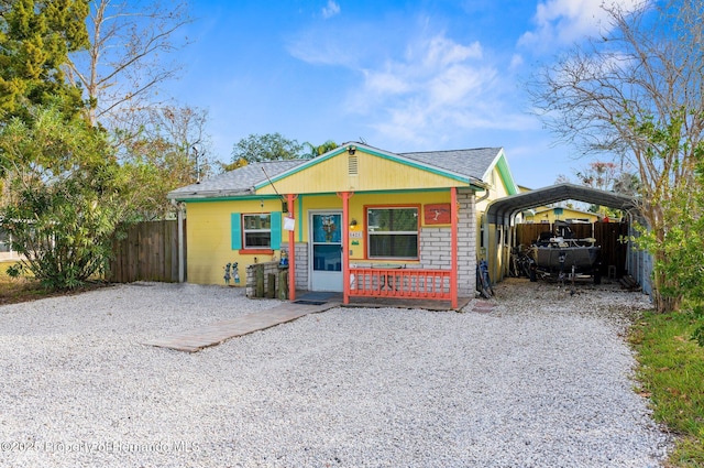 view of front of house with a carport and covered porch