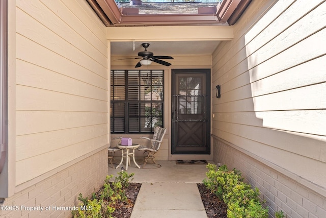 view of exterior entry with ceiling fan