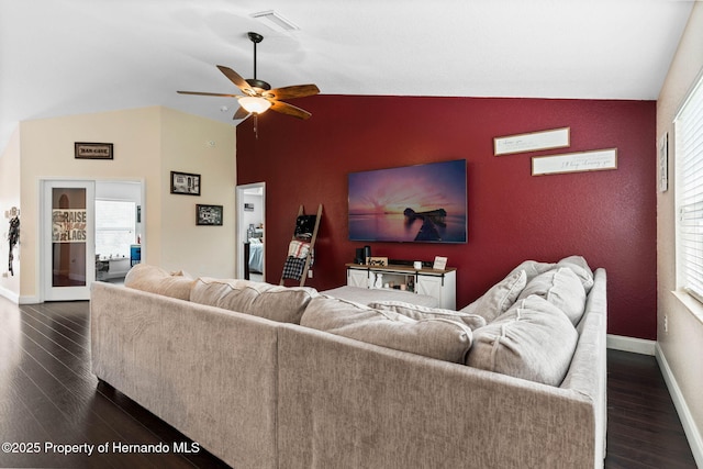 living room featuring ceiling fan, dark hardwood / wood-style floors, and lofted ceiling