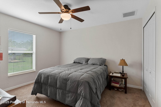 bedroom featuring a closet, ceiling fan, and light carpet