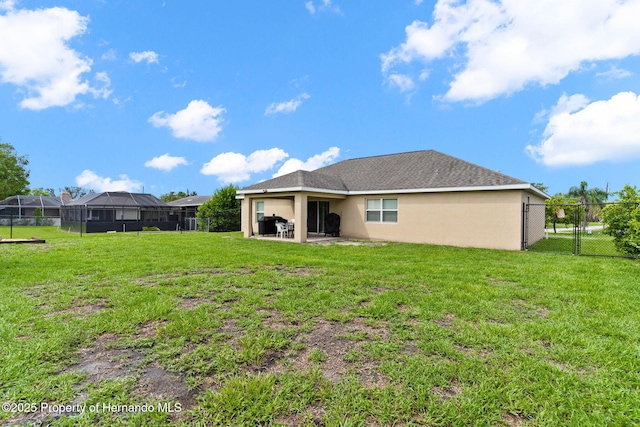 back of property featuring a patio and a lawn