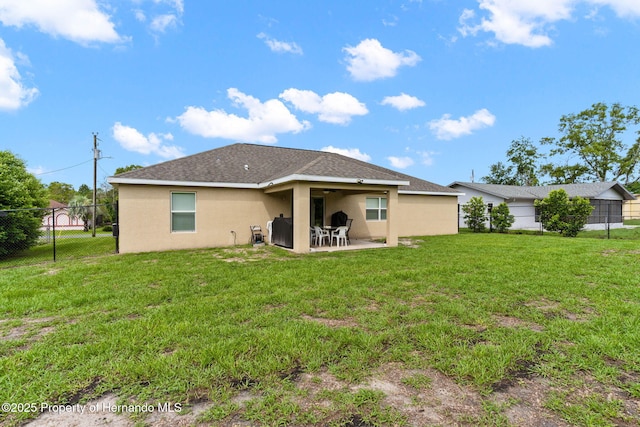 rear view of property with a patio area and a lawn