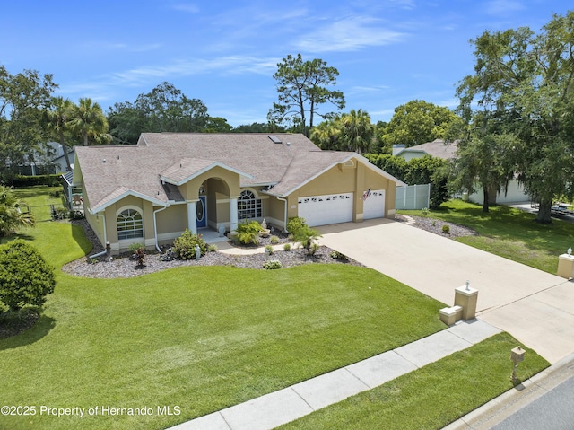 ranch-style house with a garage and a front lawn