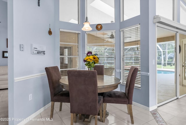 tiled dining space featuring a high ceiling