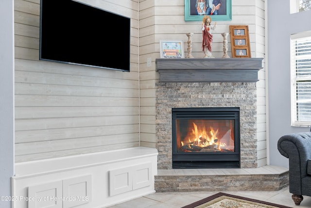 interior details featuring a stone fireplace