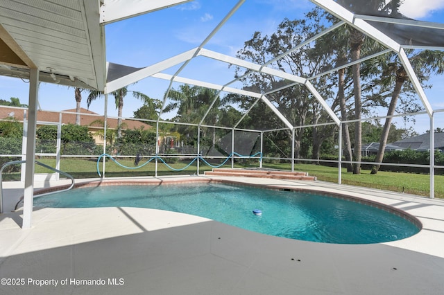 view of swimming pool with a lanai, a lawn, and a patio area