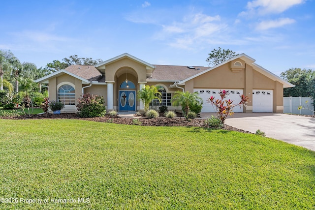 single story home featuring a garage and a front lawn