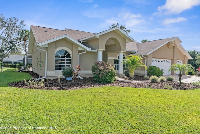 view of front of house with a garage and a front yard