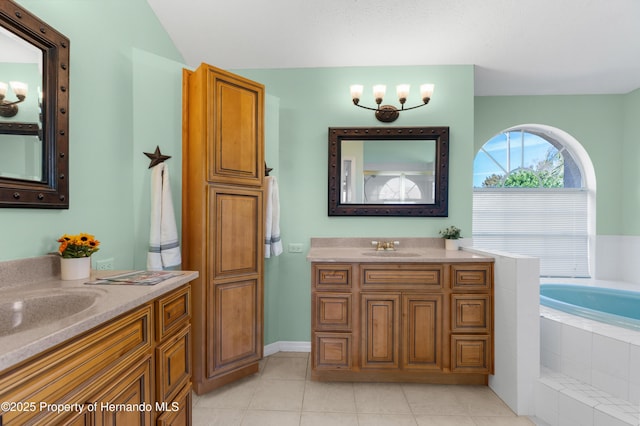 bathroom with vanity, tiled tub, and tile patterned floors