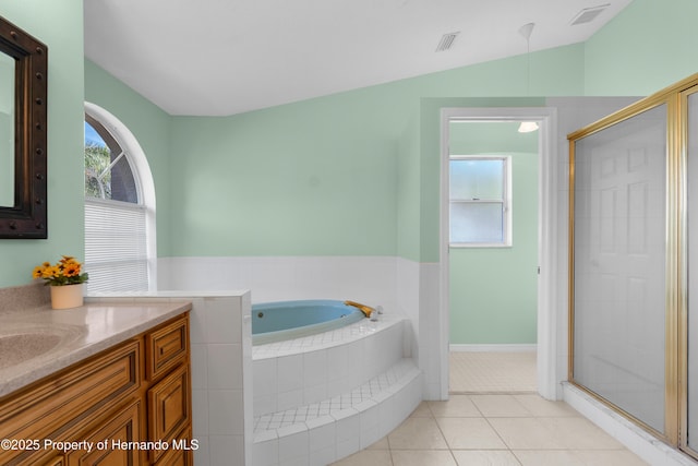 bathroom featuring lofted ceiling, vanity, tile patterned flooring, and plus walk in shower