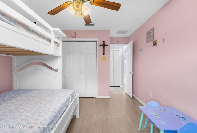 bedroom featuring ceiling fan, light hardwood / wood-style floors, and a closet