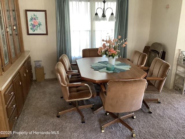 dining room with an inviting chandelier and carpet