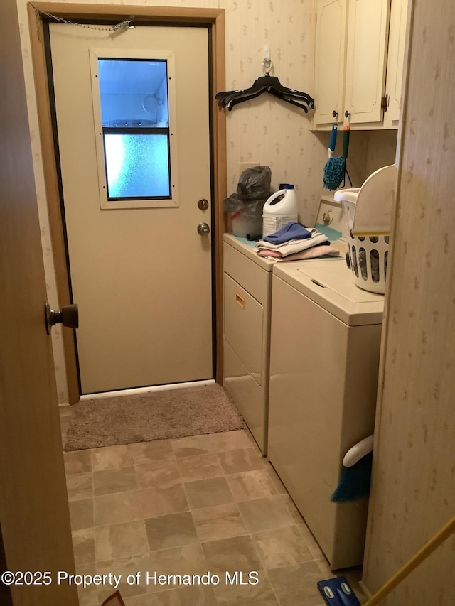 laundry room featuring cabinets and washing machine and clothes dryer