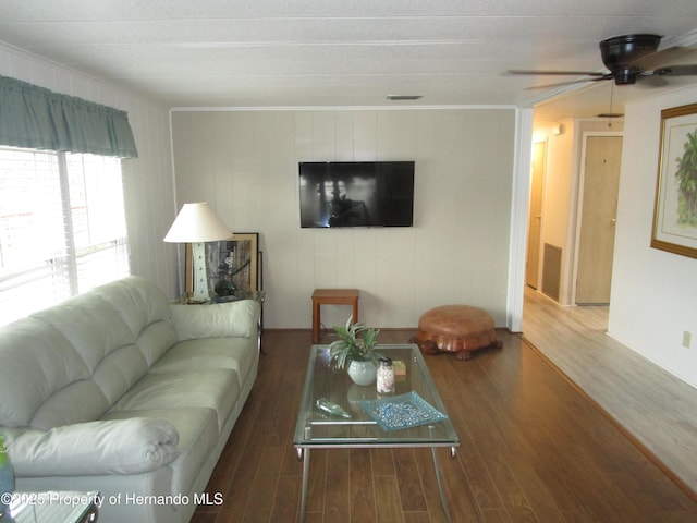 living room with ceiling fan, crown molding, and wood-type flooring