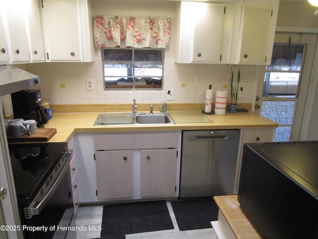 kitchen with white cabinetry, sink, dishwasher, and black / electric stove