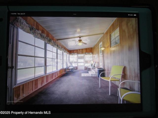 unfurnished sunroom featuring lofted ceiling and ceiling fan