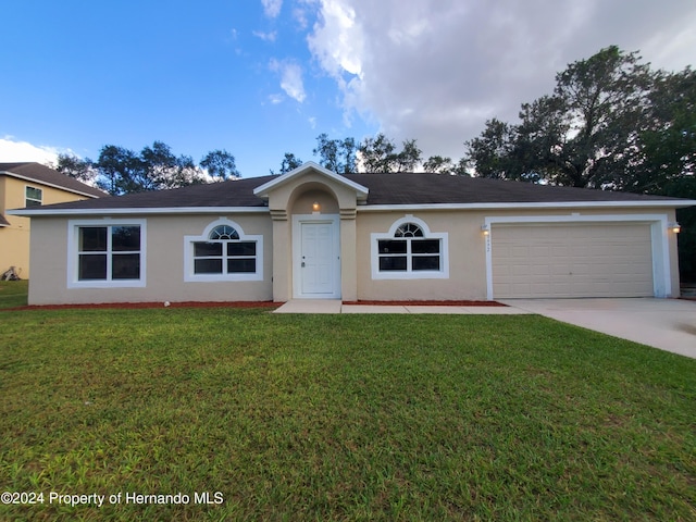 single story home with a front lawn and a garage