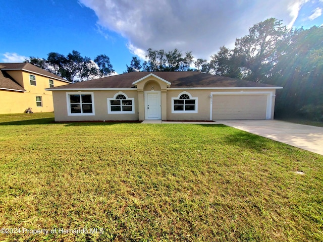 ranch-style home featuring a front lawn and a garage