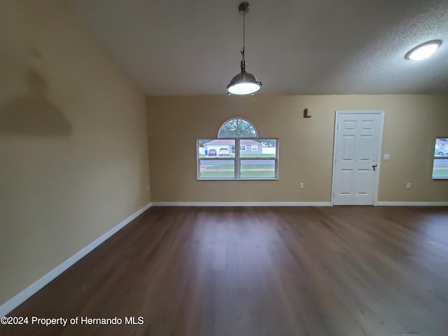 interior space with dark hardwood / wood-style flooring and a textured ceiling