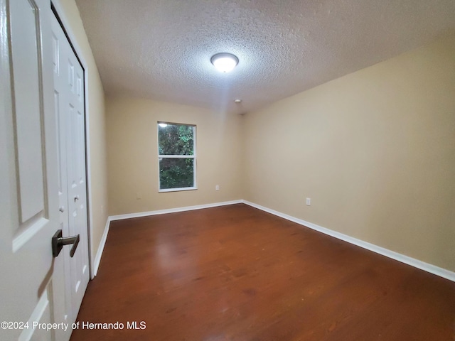 unfurnished bedroom featuring a textured ceiling and hardwood / wood-style flooring