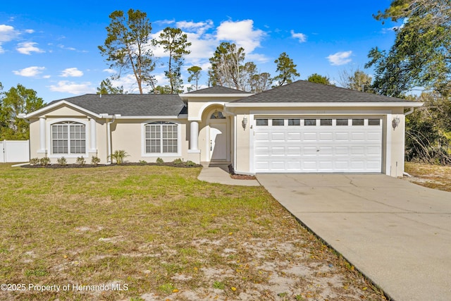 ranch-style house featuring a garage and a front yard