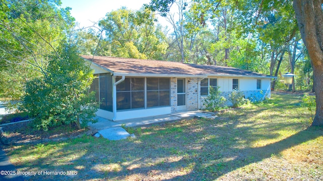 view of front of home featuring a sunroom and a front yard