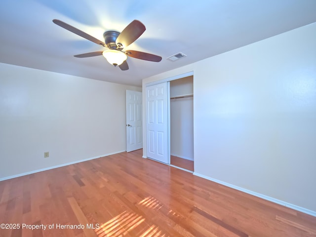 unfurnished bedroom featuring a closet, ceiling fan, and wood-type flooring