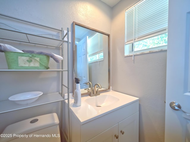 bathroom featuring vanity and toilet