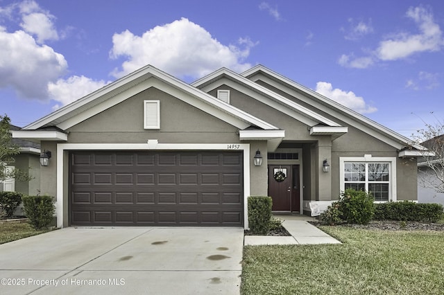 view of front of home with a garage and a front lawn