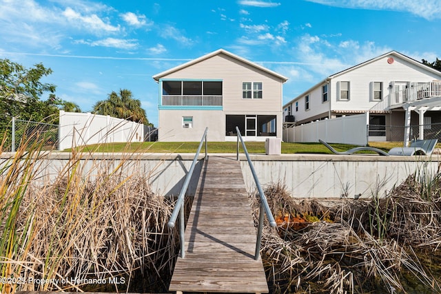 rear view of property featuring a sunroom