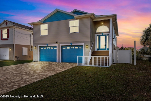 view of front of house featuring a garage and a yard