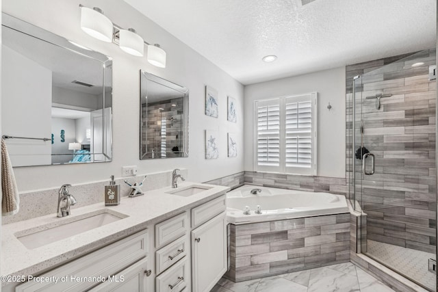 bathroom with vanity, plus walk in shower, and a textured ceiling