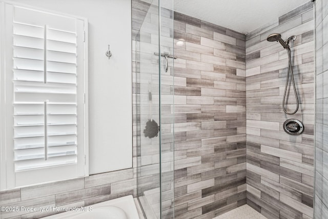 bathroom with shower with separate bathtub