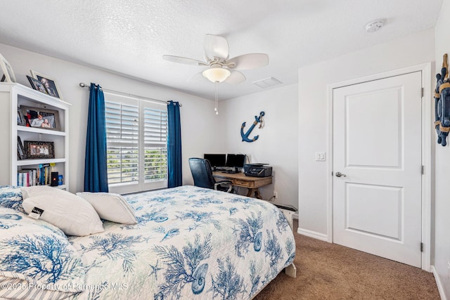 bedroom featuring ceiling fan, carpet, and a textured ceiling