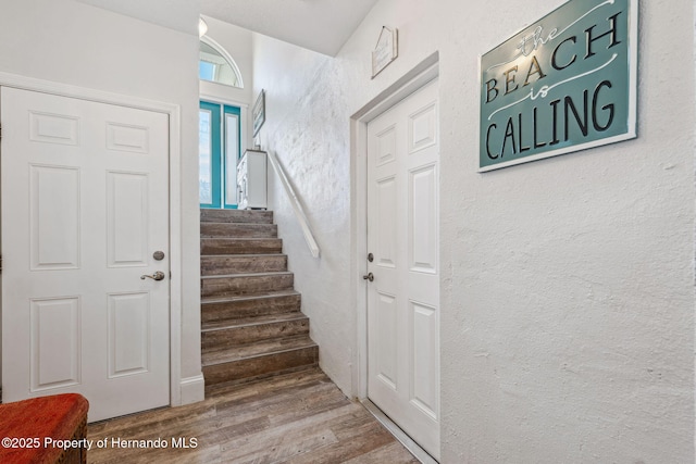 stairs featuring hardwood / wood-style floors