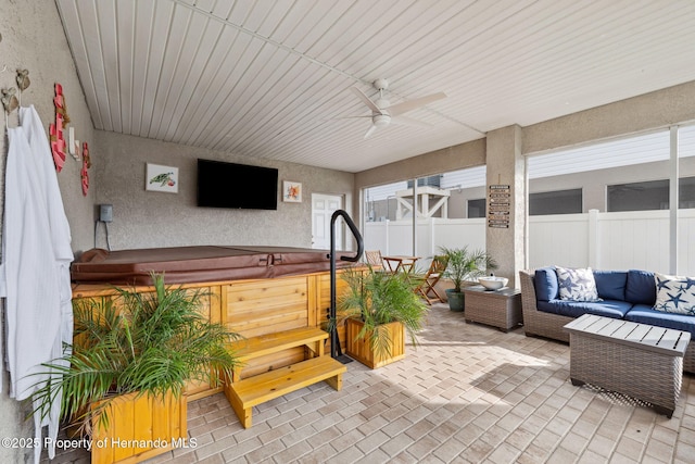 view of patio / terrace featuring a hot tub, an outdoor hangout area, and ceiling fan