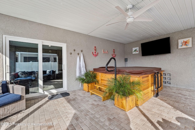 view of patio featuring a hot tub and ceiling fan