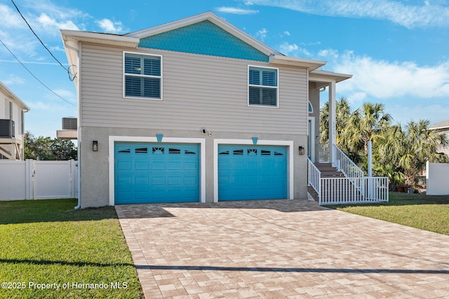 view of front of home featuring a garage and a front yard