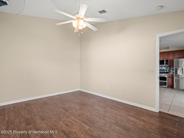 spare room with ceiling fan, dark hardwood / wood-style floors, and lofted ceiling