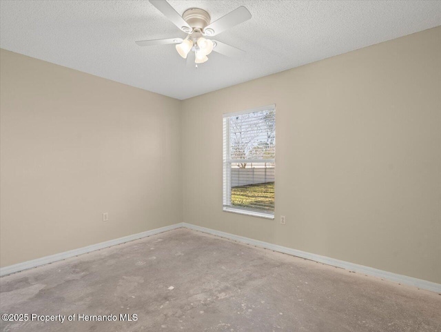 empty room featuring ceiling fan and a textured ceiling