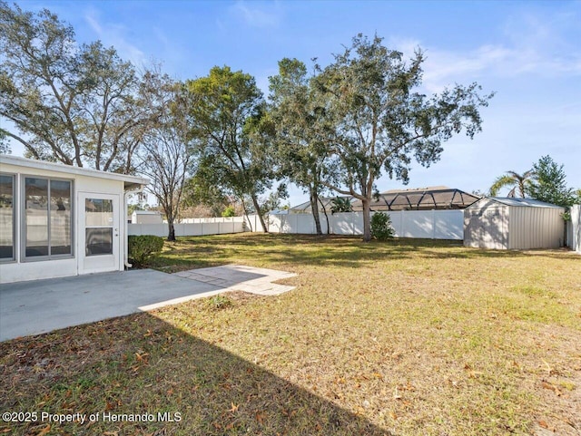 view of yard with a shed and a patio