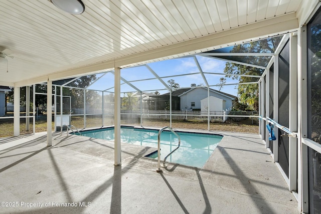 view of swimming pool with a lanai and a patio area