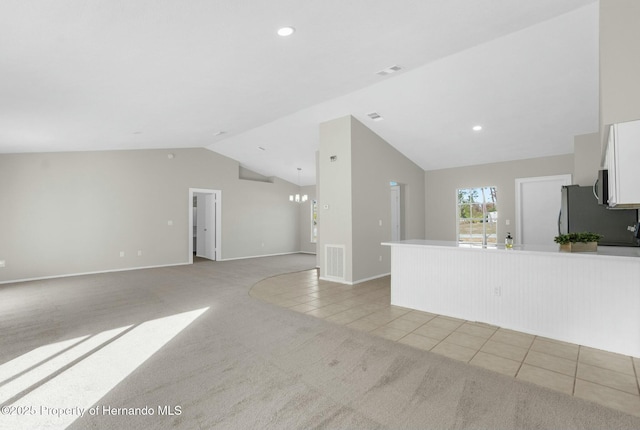 unfurnished living room featuring lofted ceiling and light tile patterned floors