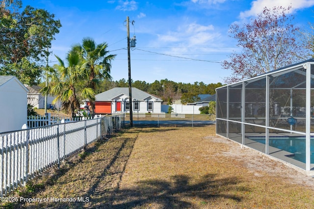 view of yard featuring a lanai and a fenced in pool