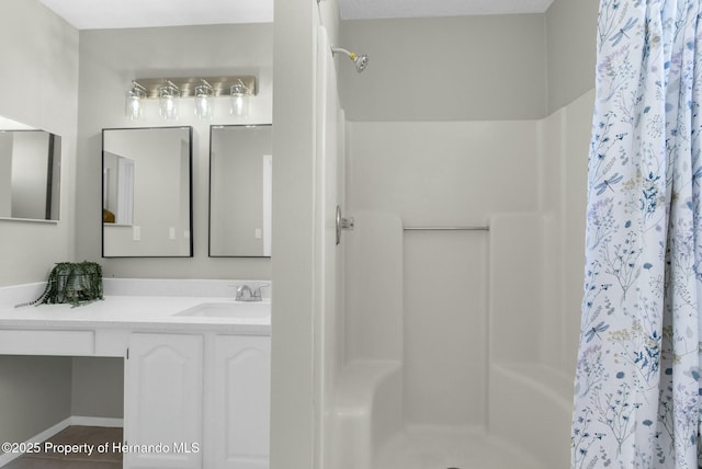 bathroom with a shower with curtain and vanity