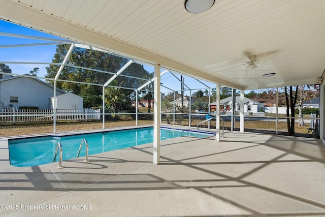 view of swimming pool with a lanai, ceiling fan, and a patio