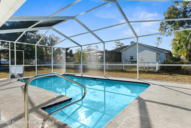 view of pool with a patio area and a lanai