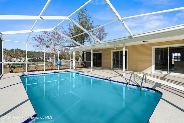 view of pool with a lanai, ceiling fan, and a patio