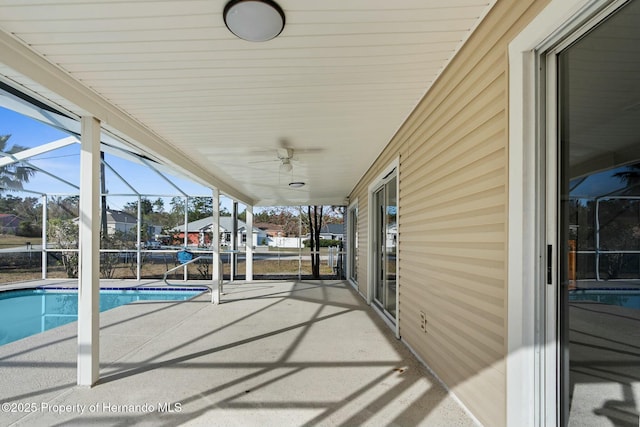 exterior space featuring a patio area and glass enclosure